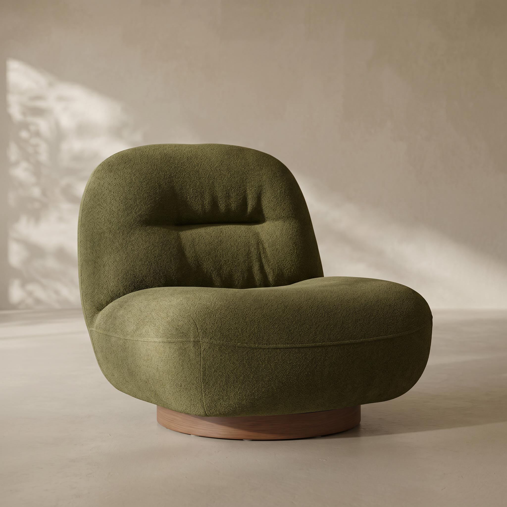 An olive green tufted lounge chair with a rounded, cloud-like silhouette and a natural wood swivel base, set against a warm beige textured wall with soft leaf shadows.