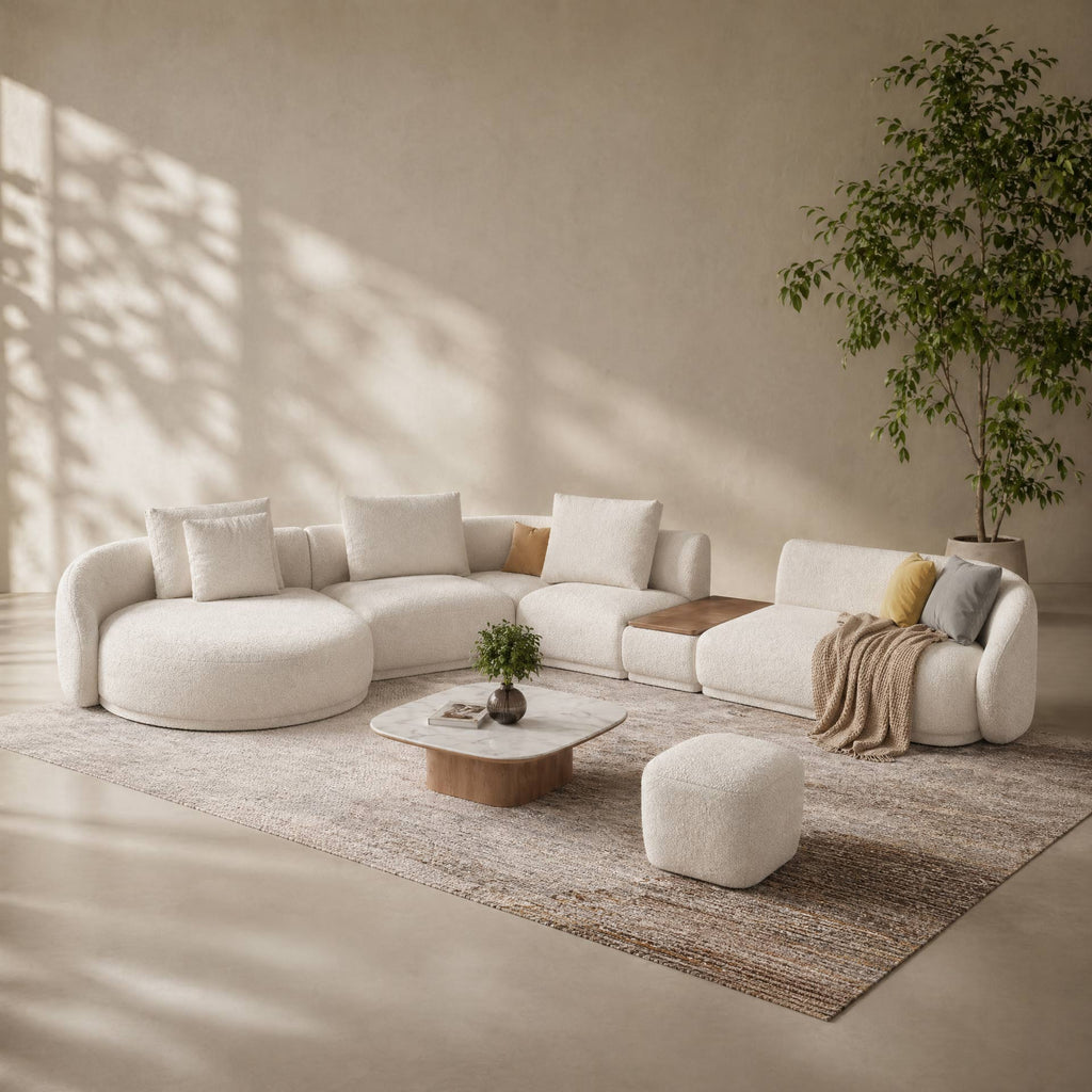 Modern living room with a white sectional sofa, coffee table, and decorative items.