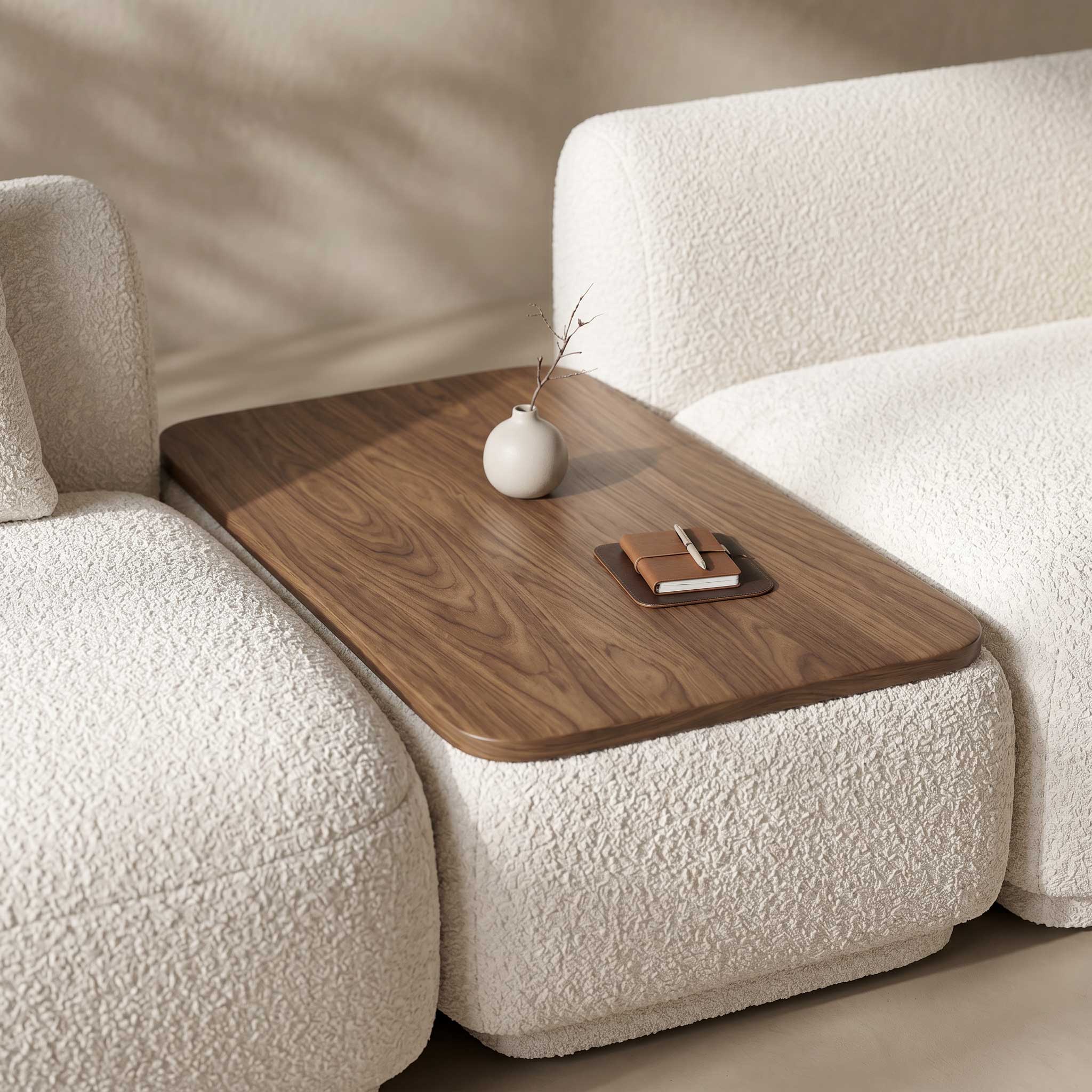 Wooden coffee table attached to a white sofa with decorative items on top