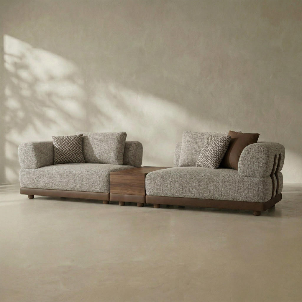 Modern gray sofa with wooden accents in a minimalistic room.