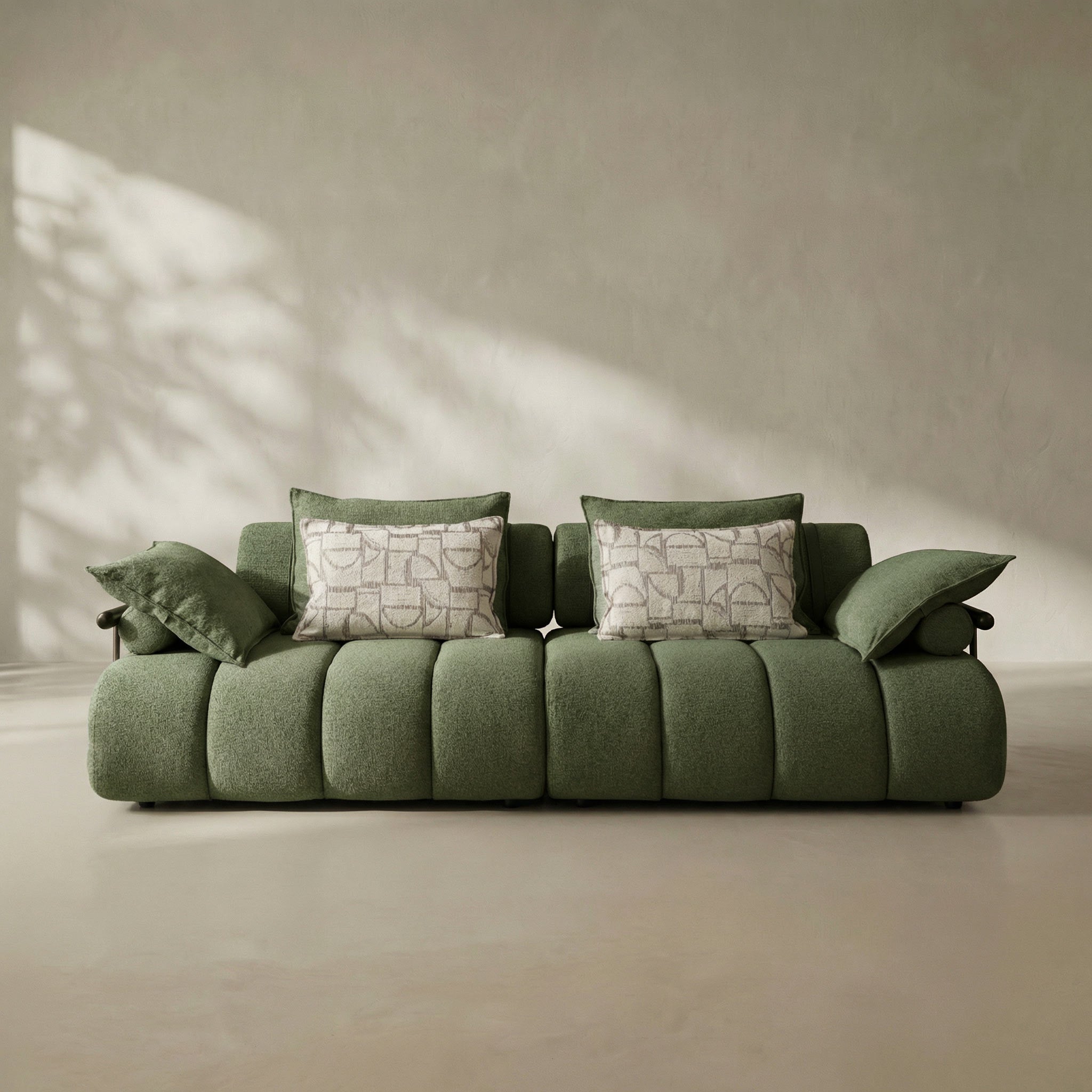 Green sofa with patterned cushions in a minimalistic room