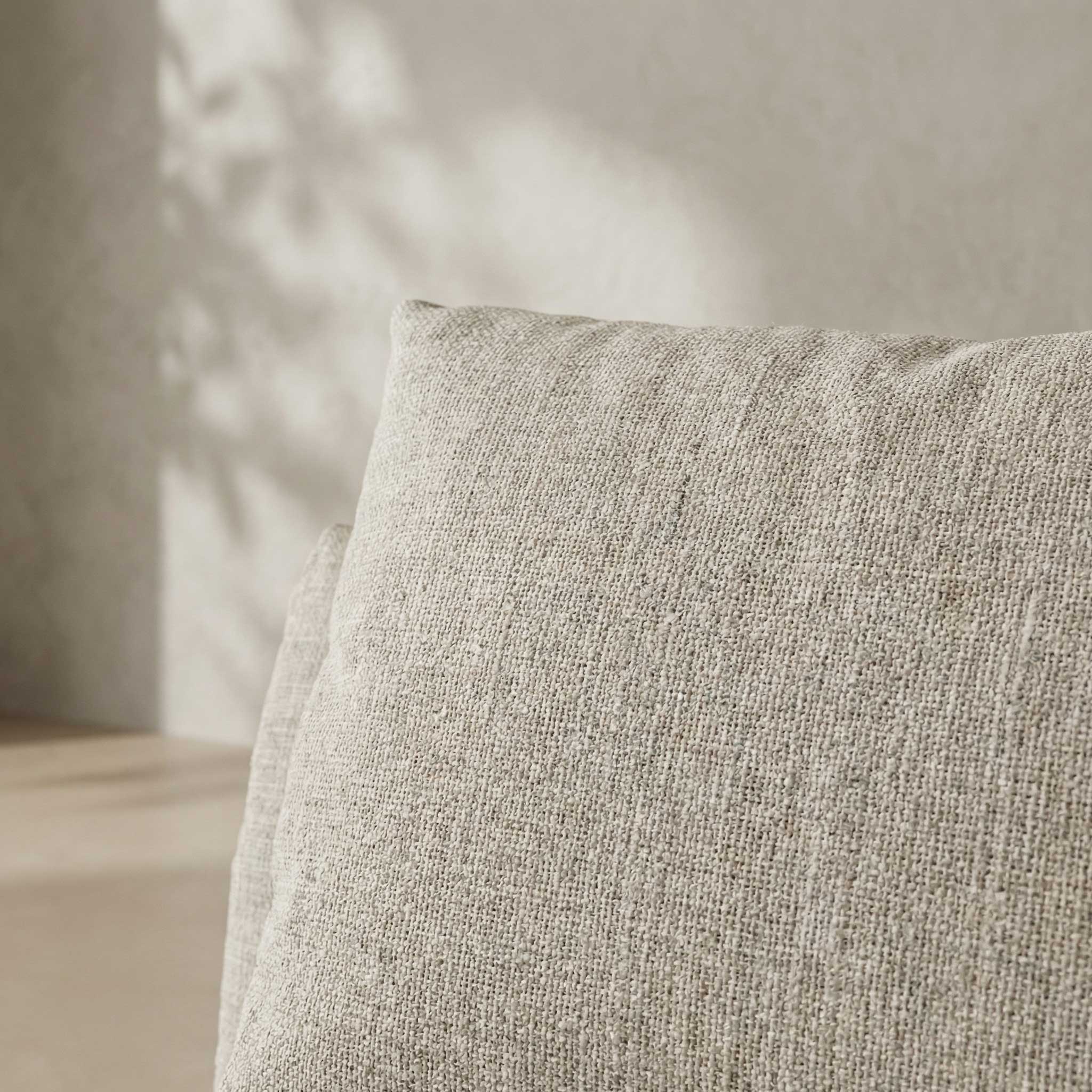 Textured gray cushion on a neutral background