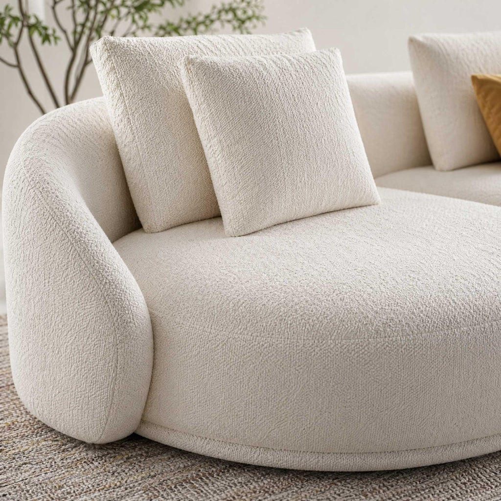 Beige textured sofa with cushions in a living room setting