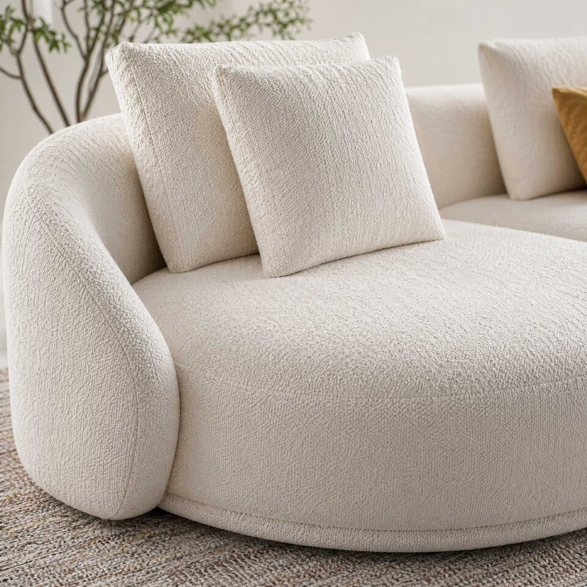 Beige textured sofa with cushions in a living room setting