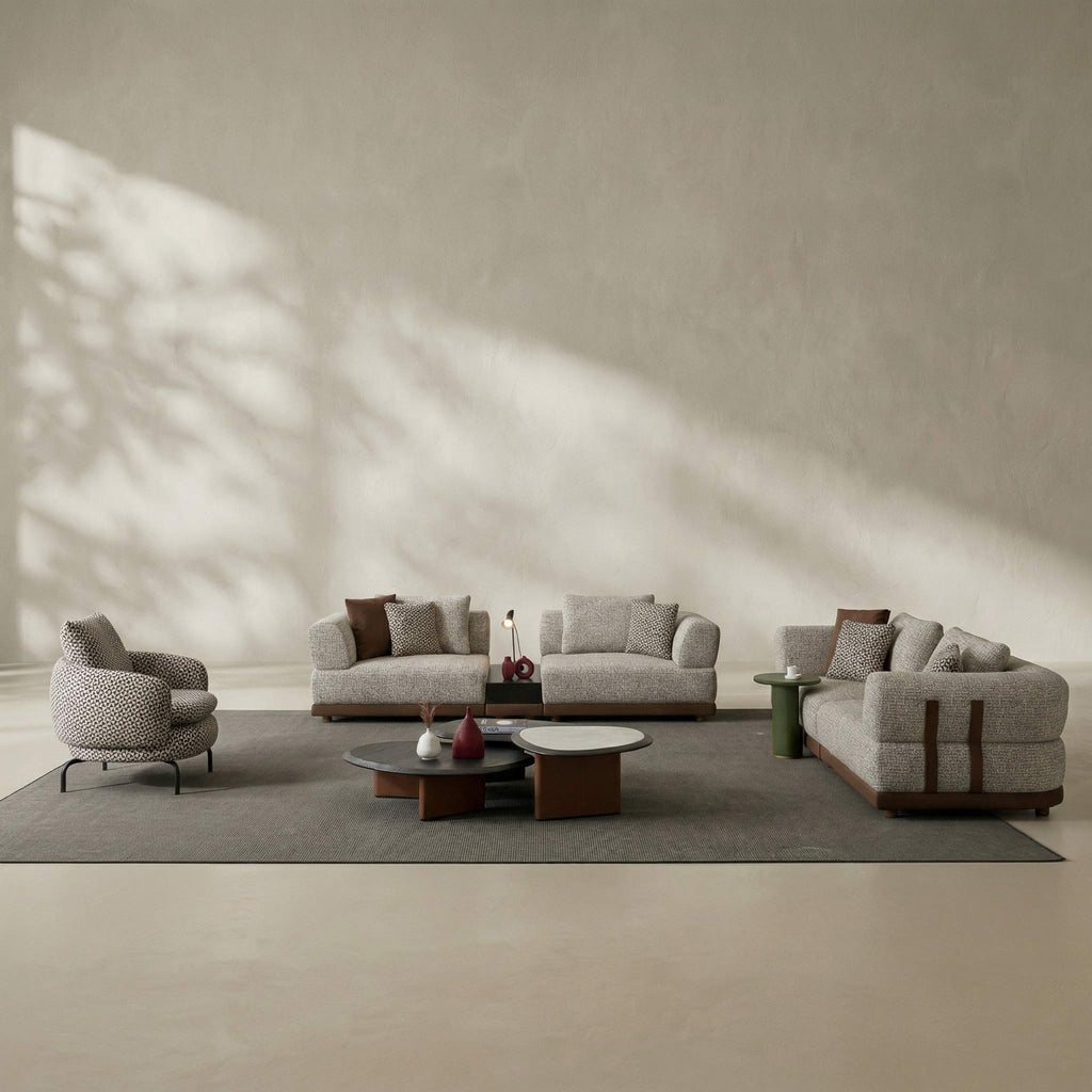 Modern living room with gray sofa set and armchairs in a minimalistic setting.