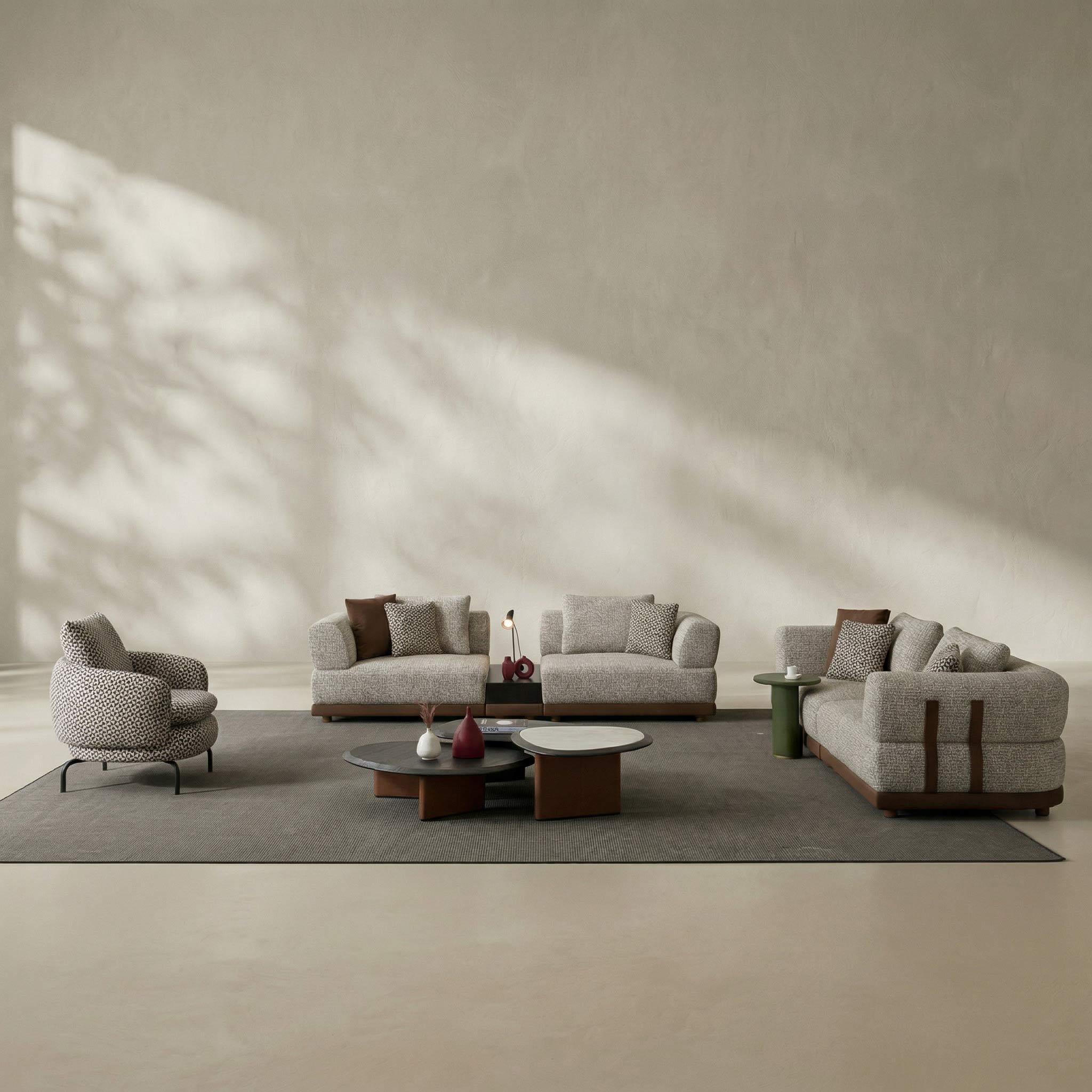 Modern living room with gray sofa set and armchairs in a minimalistic setting.