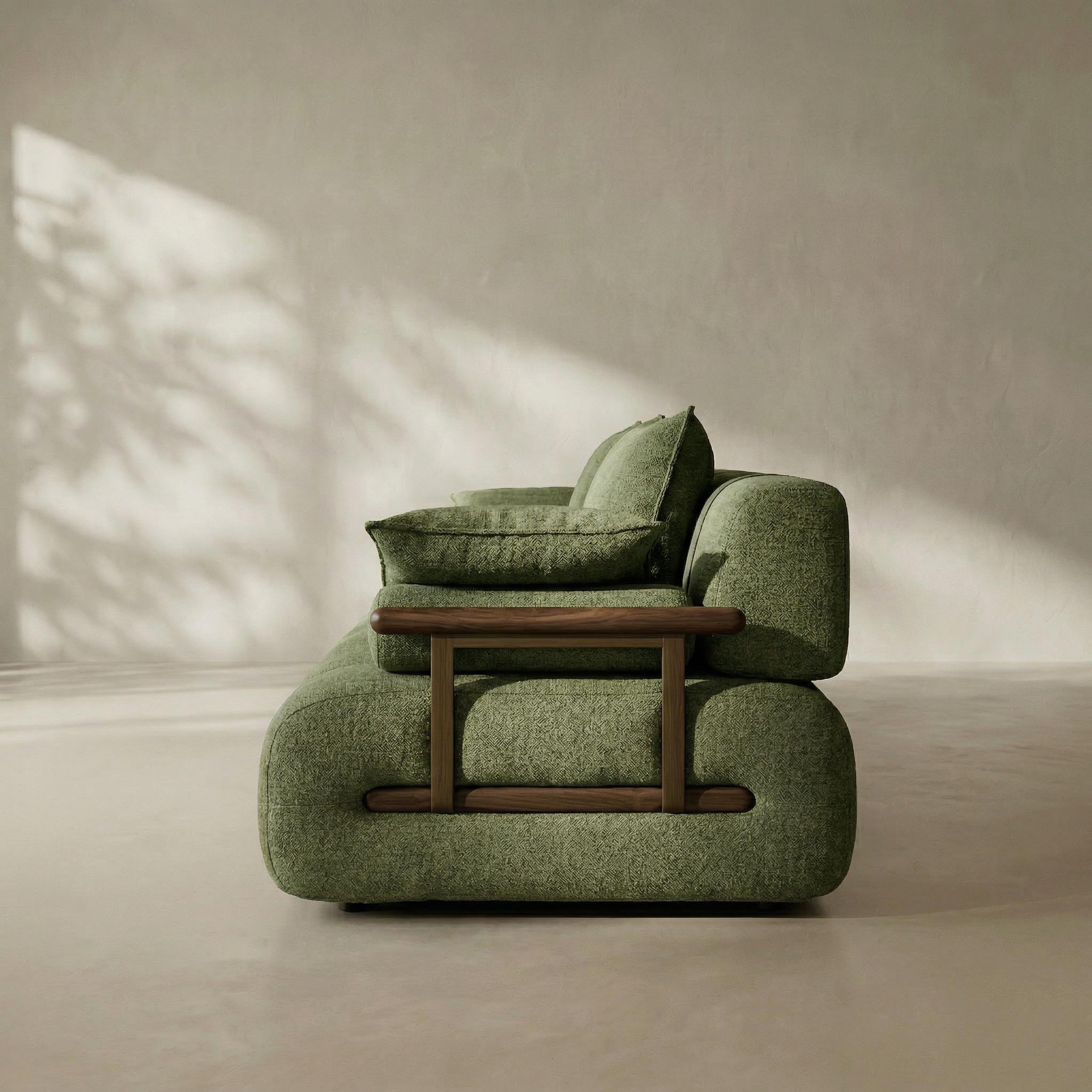 Green armchair with wooden armrests in a minimalistic room