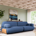 Blue sofa in a modern living room with abstract art on the wall.