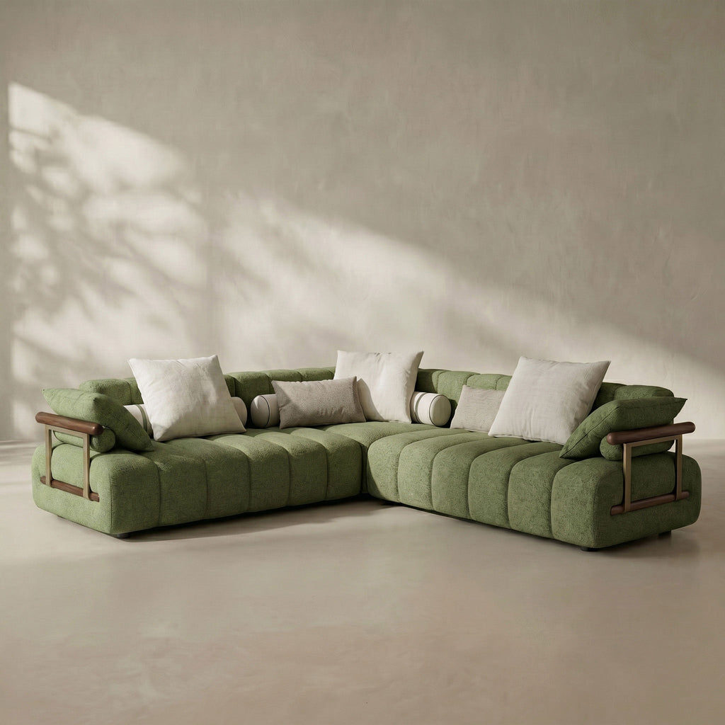 Green sectional sofa with wooden armrests in a minimalistic room.