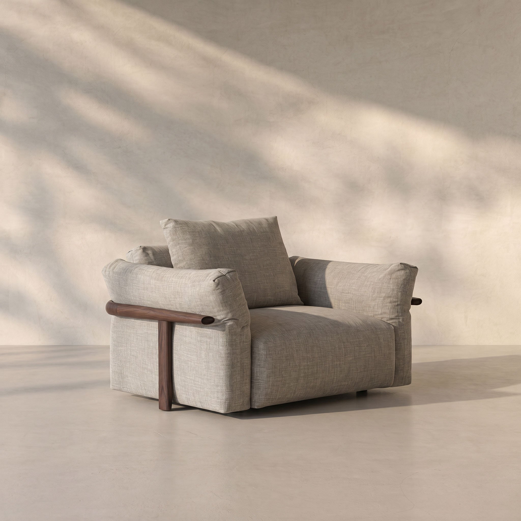 Gray armchair with wooden armrests in a minimalistic setting
