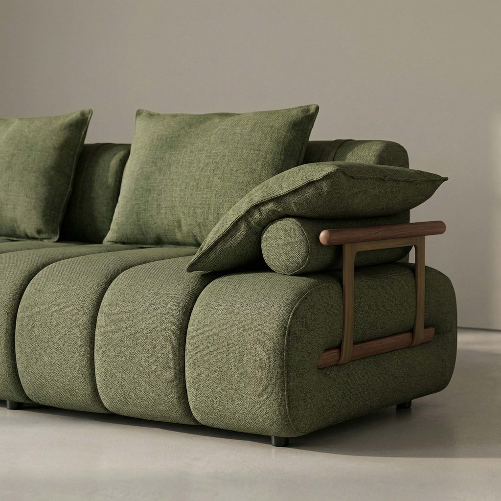 Green sofa with wooden armrest in a minimalistic room