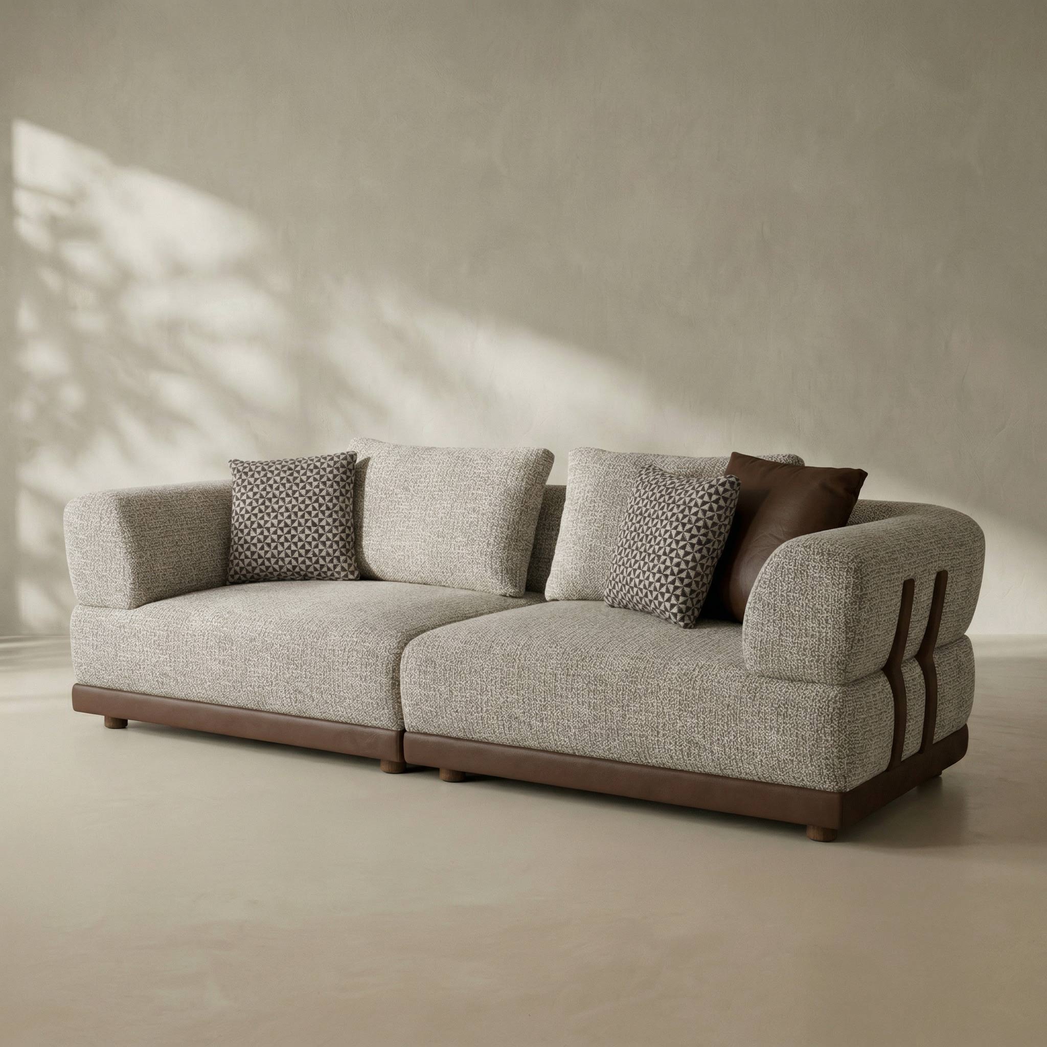 Gray sofa with patterned cushions on a beige floor and wall