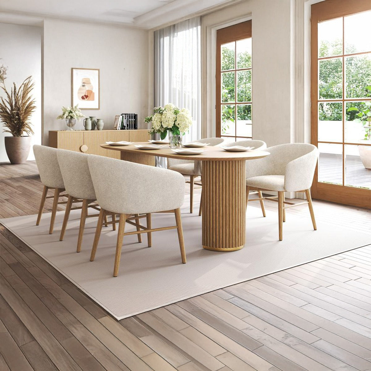 Arco contemporary dining set showing oval table and curved dining chairs set against large windows with a view to an outdoor patio.