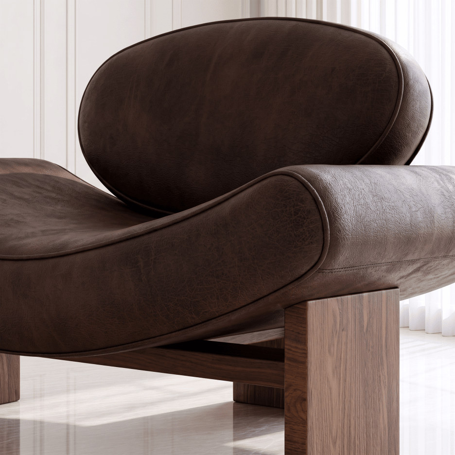 A close-up of a modern lounge chair with curved dark brown leather upholstery and a wooden frame, set in a bright interior with white paneled walls and light flooring.