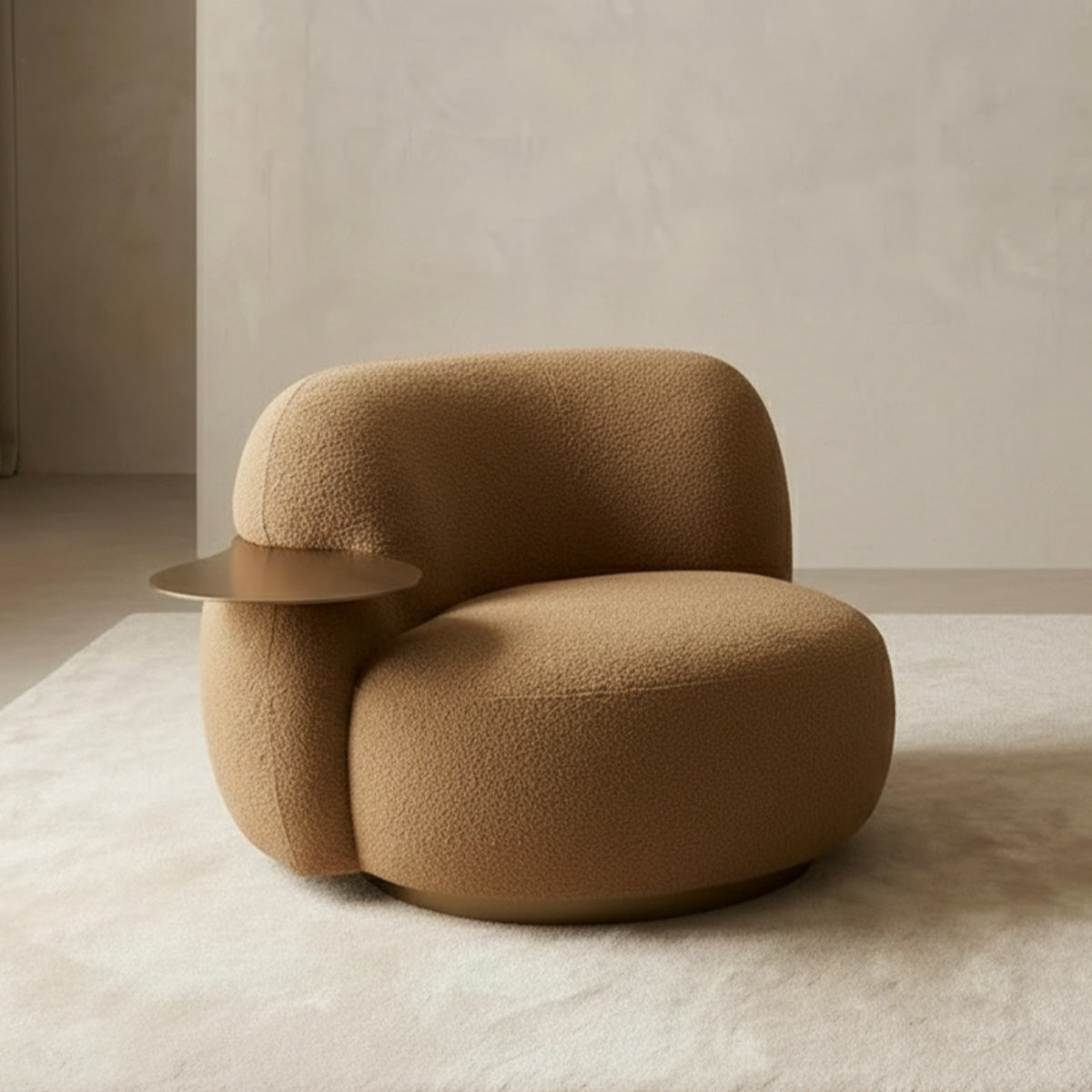 Single-seater curved lounge armchair in caramel bouclé fabric with a rounded silhouette, integrated round brass side table, and a gold base.