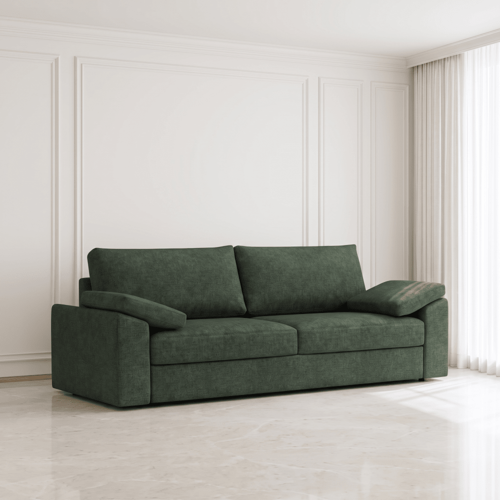 A dark green fabric sofa with two back cushions and wide armrests, placed in a bright, modern room with white paneled walls and light marble flooring.