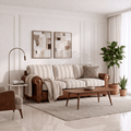 A mid-century modern living room featuring a brown leather sofa with beige and white striped cushions, a matching striped throw blanket, a wooden coffee table, and a light gray rug. The room has white paneled walls, a floor lamp, and potted plants.