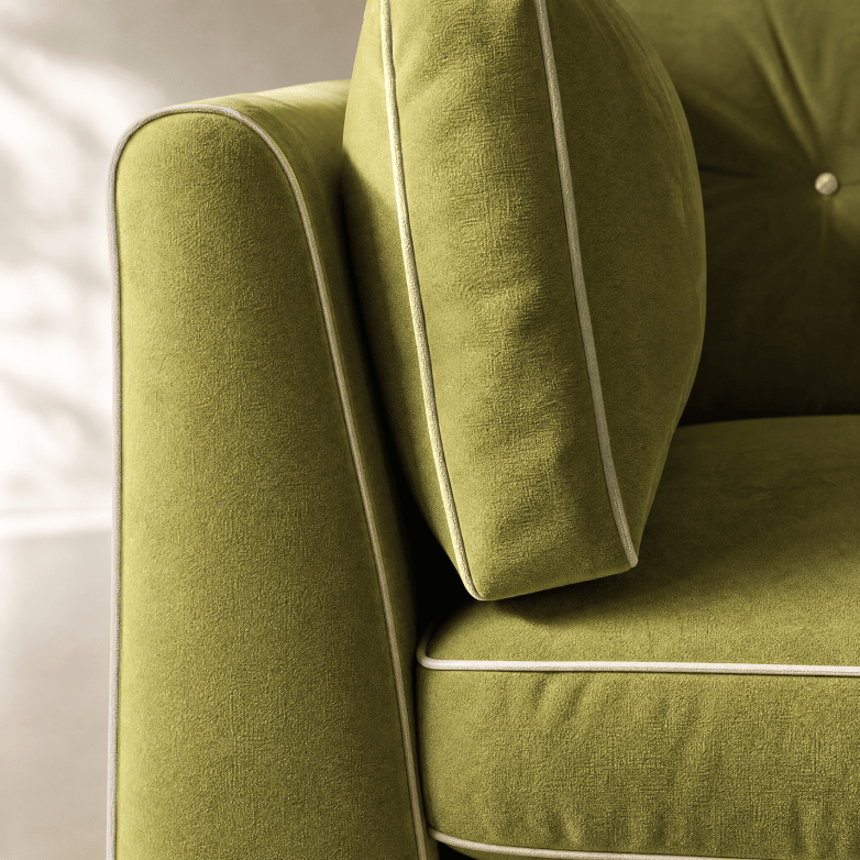 Close-up of an olive green upholstered armchair with matching back cushion and white piping trim.
