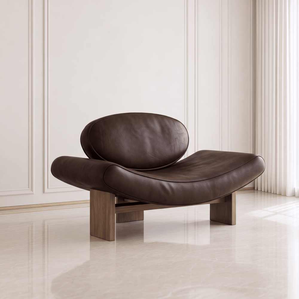 A modern curved lounge chair with dark brown leather upholstery and a wooden base, set against a minimalist cream paneled wall and light-colored floor.